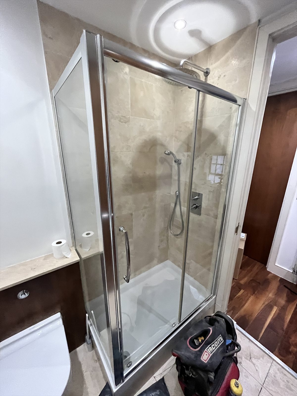 Finished shower room with a glass enclosure, tiled walls and a thermostatic shower valve