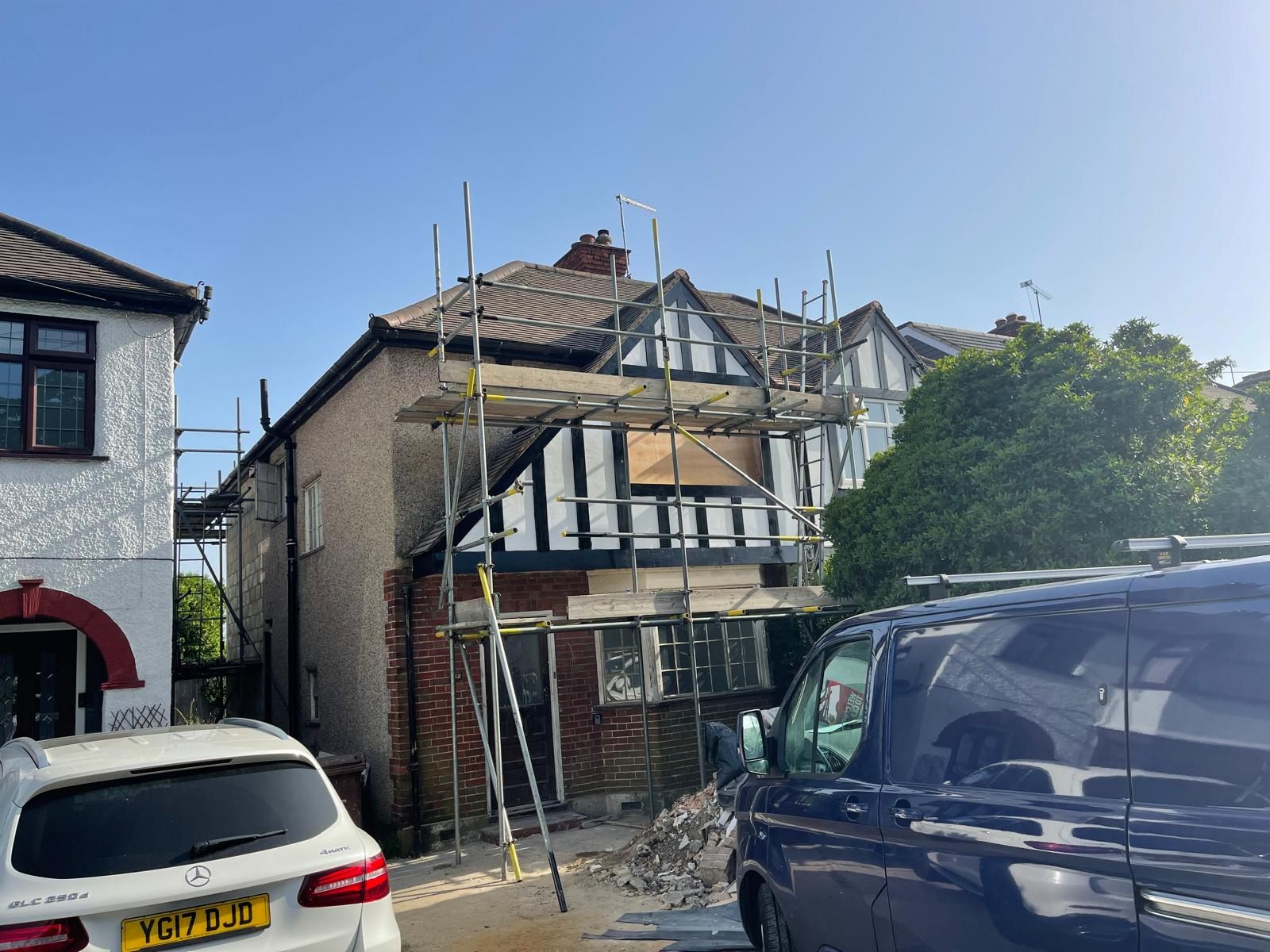 The build viewed from the driveway, scaffolded with the new gable and window openings formed