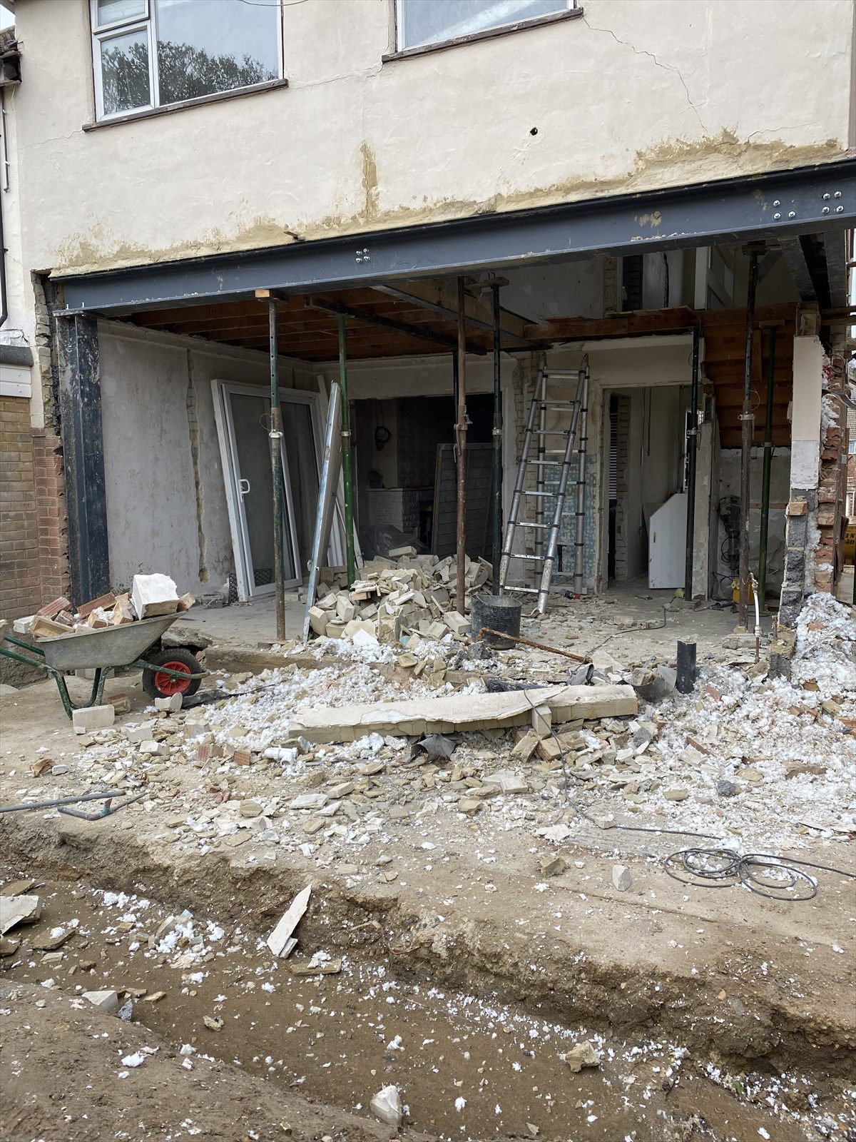 A new steel-supported opening formed in a rear extension, with insulation boards and brickwork exposed