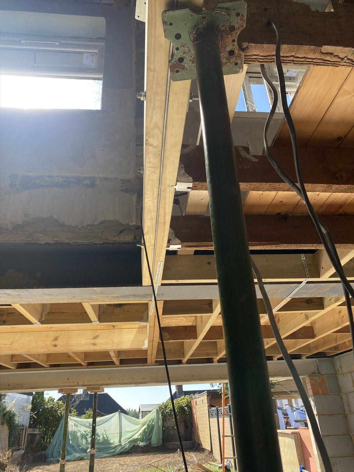 Temporary steel propping supporting a first-floor extension during structural work